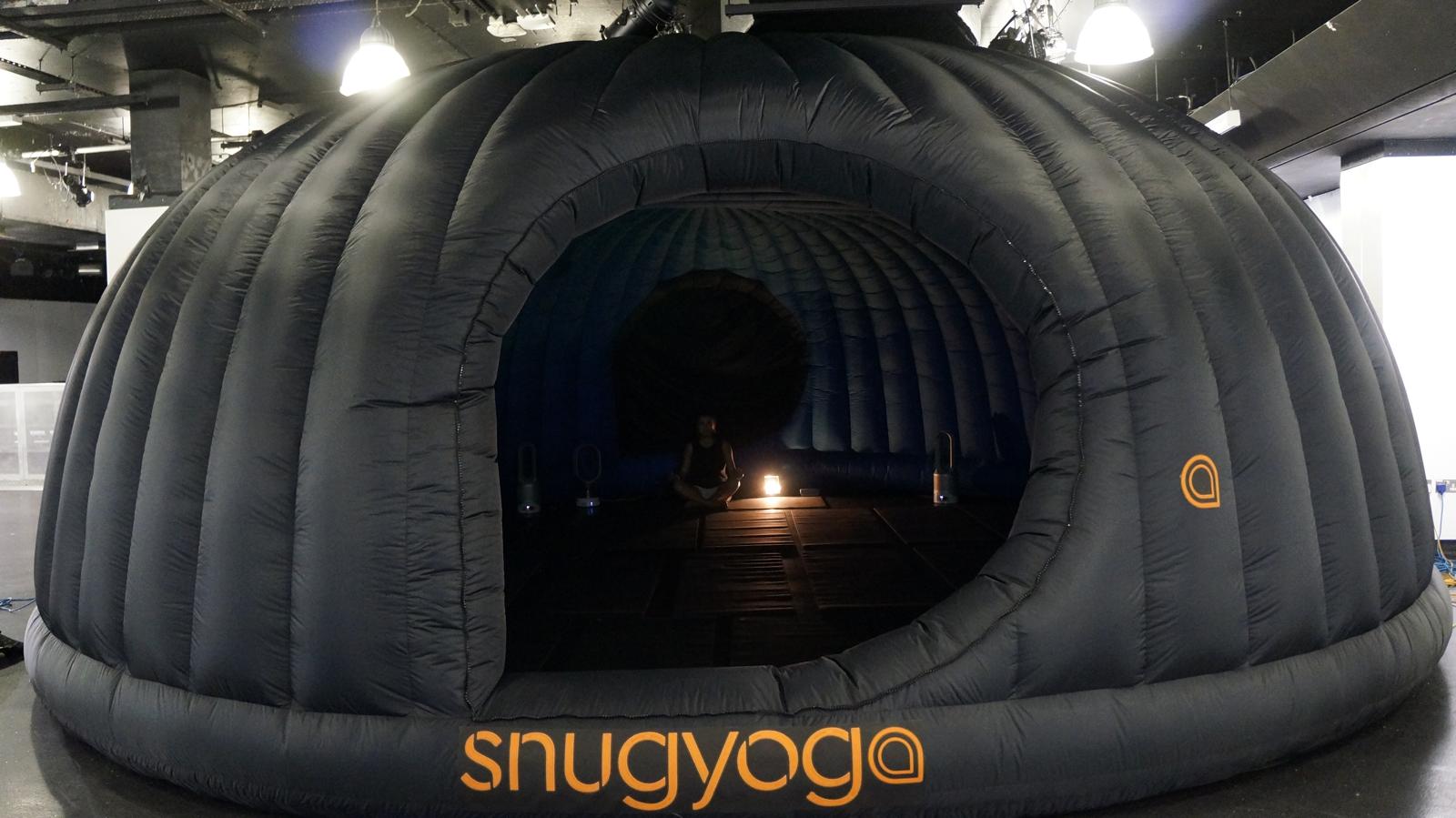 Real Snug Yoga branded pod with person meditating inside
